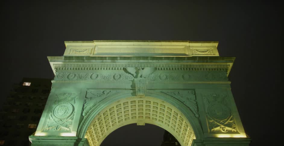 A large stone monument fills the sky at night