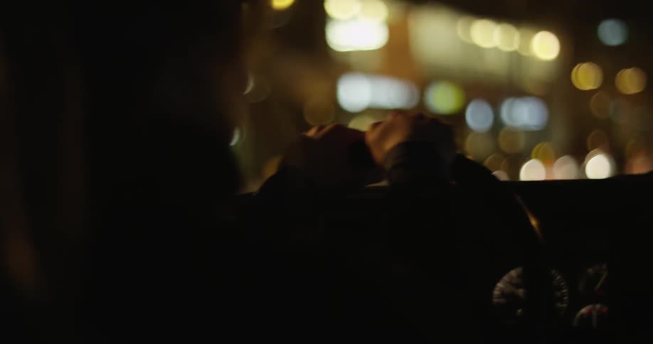 A person drives a car at night