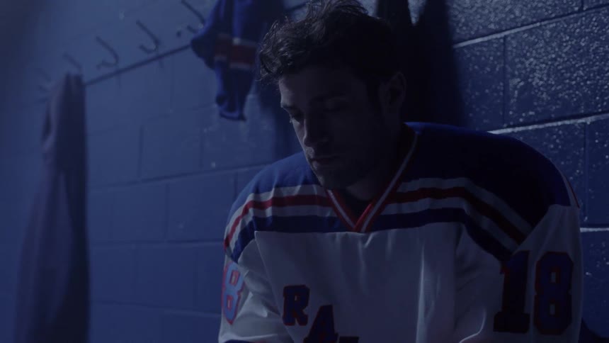 Man sits in hockey locker room