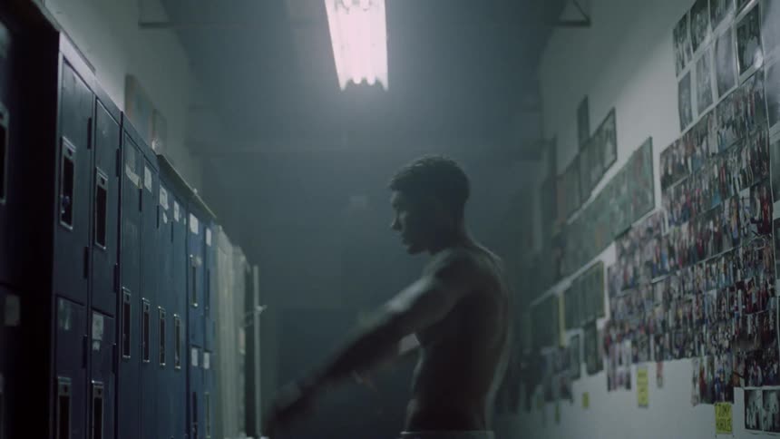 A man slams his hands against the lockers