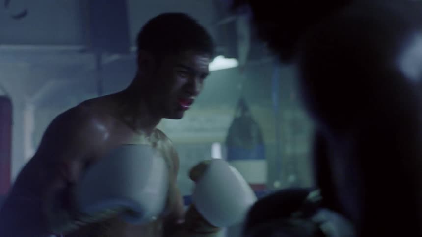 Boxers fight in a boxing ring