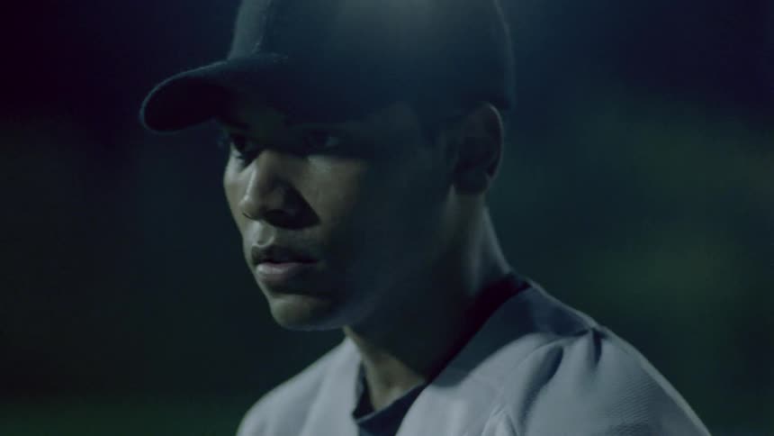A pitcher is concentrating as he prepares to pitch