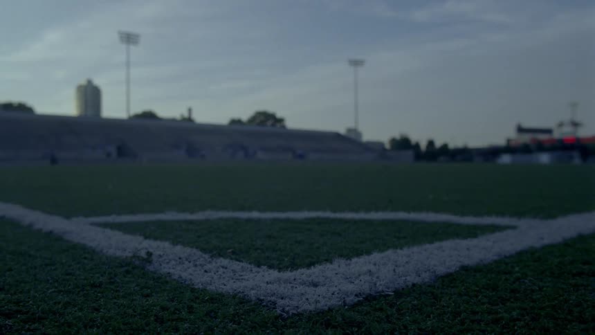 A corner of a soccer field with bleachers in the distance