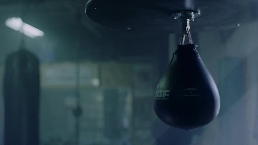 A punching bag swings in a gym