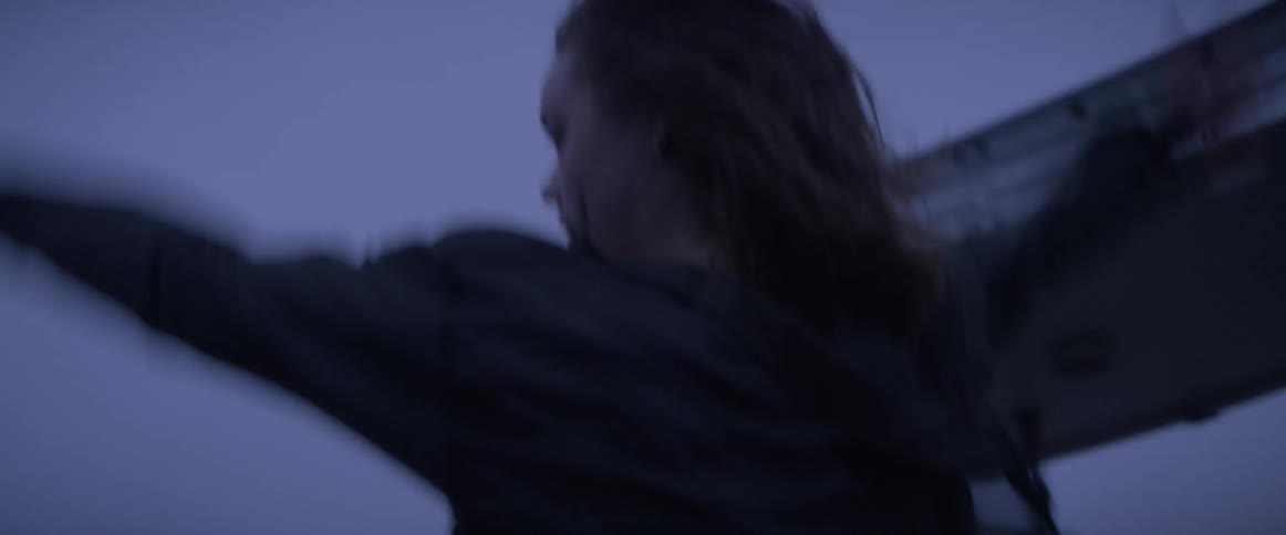 A woman is dancing outside at dawn