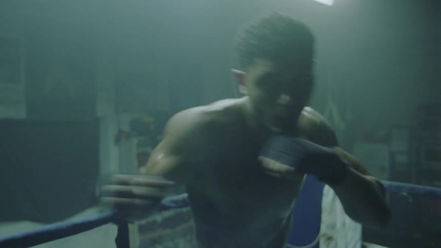 A man is shadowboxing in the ring