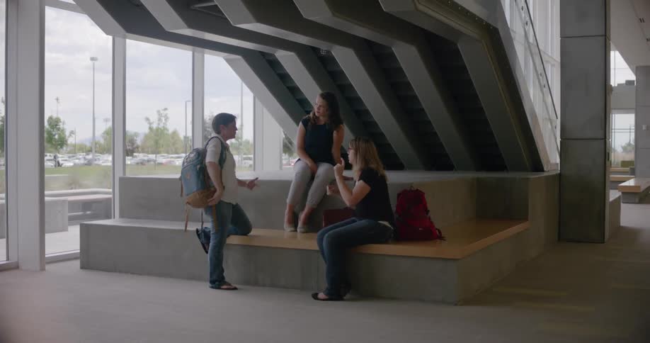 A group of kids are using sign language while sitting on some concrete steps