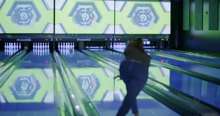 A woman is bowling