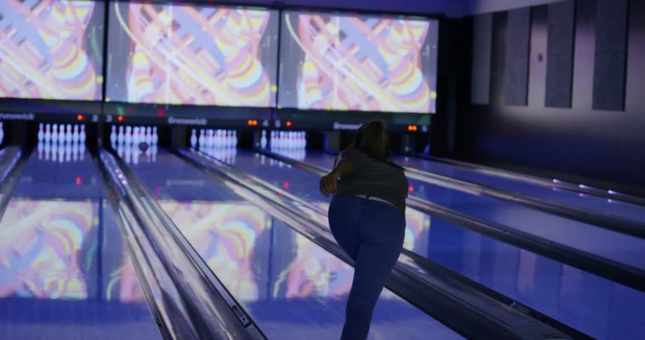 Woman bowls and celebrates with friends