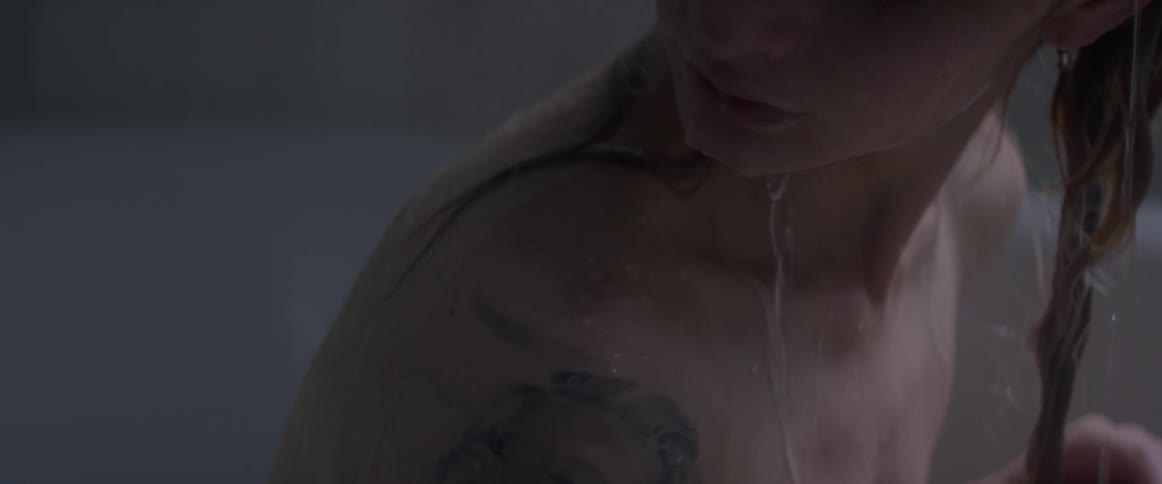 Water runs over a showering person