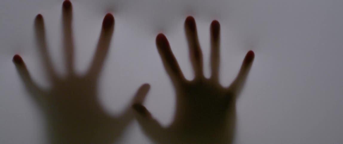 Someone rubs their hands against a translucent cloth