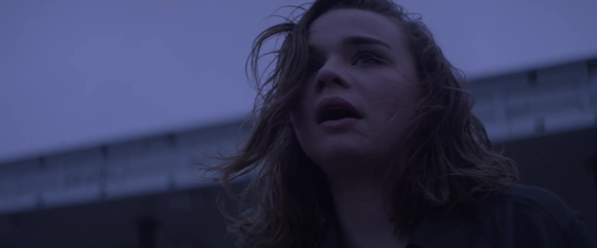 A woman looks distraught outside