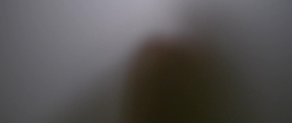 Person's shadow as they stand behind a white screen