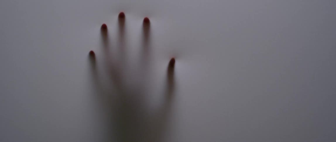 A person touches a translucent cloth