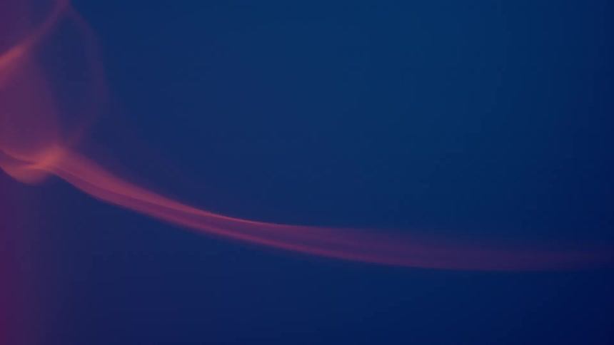 Red smoke against a blue background swirls in the air