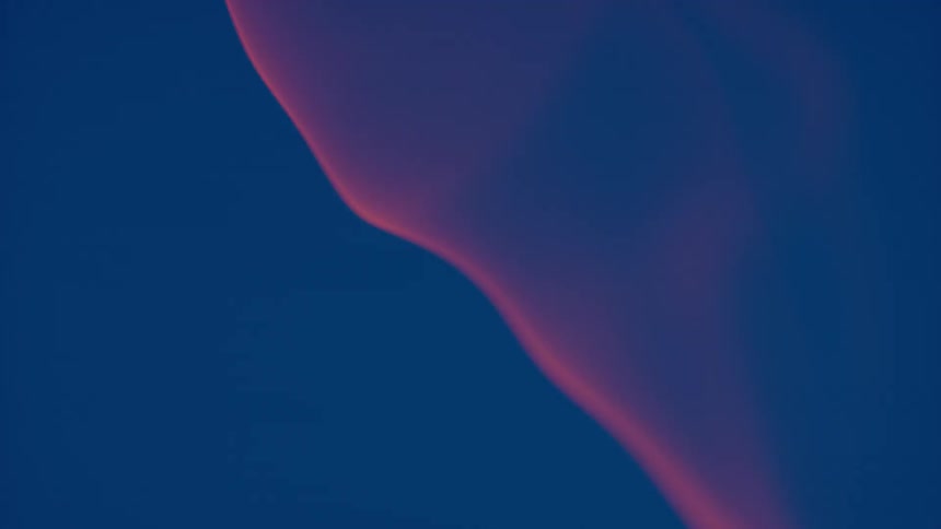 Red smoke against a blue background is billowing in the air