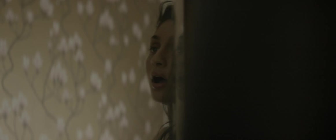 A woman looks at herself in a mirror
