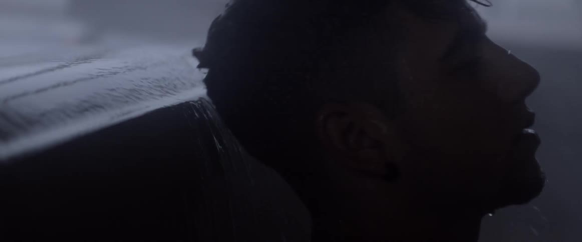 Water splashing off of a surface and a dark object hits it