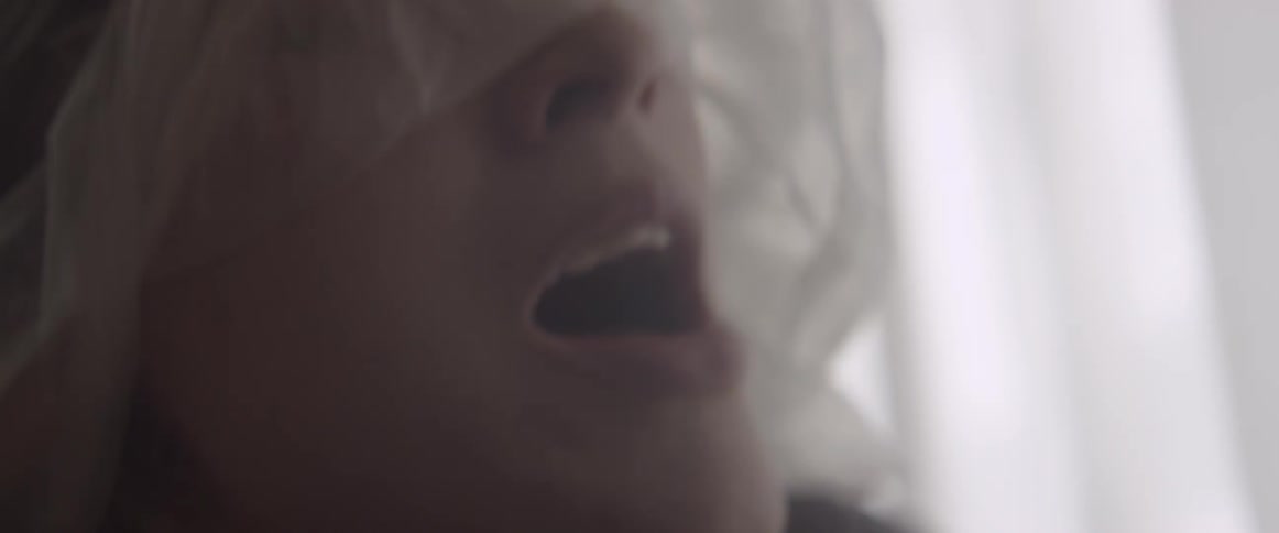 Woman takes a plastic bag off of her face