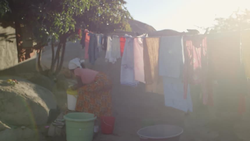 A bunch of colorful clothing is being hung up to dry in the sun