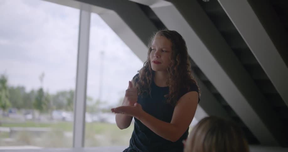 Three people are having a conversation using sign language