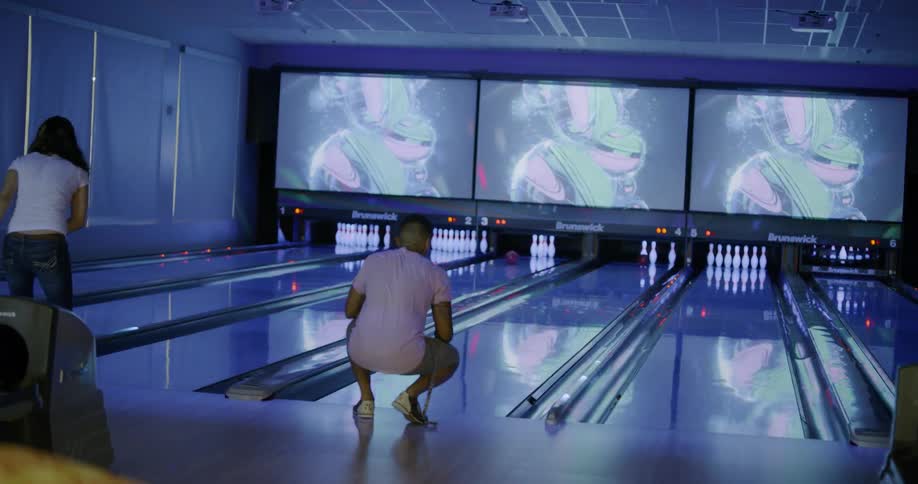 A man and woman are bowling together