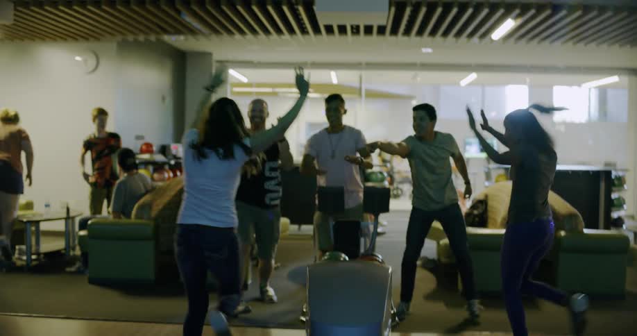 A woman celebrates a bowling shot
