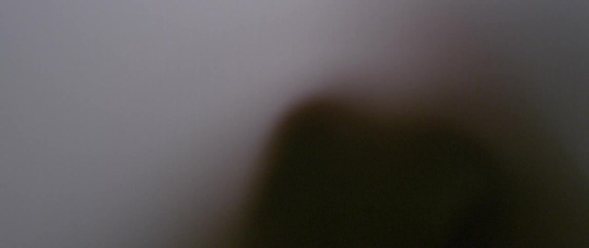 A person moves behind a translucent sheet