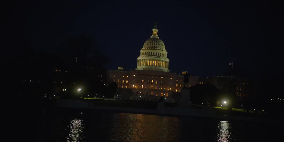 The capitol building is being filmed at night