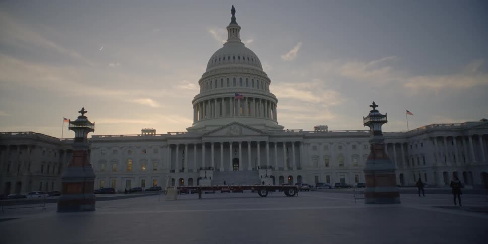 Flag flap in the wind outside the us capitol building at dawn