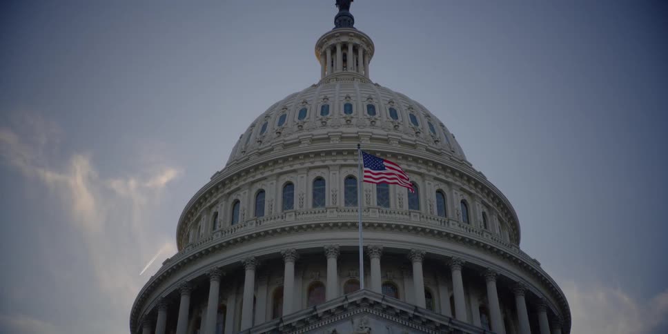 The capitol buildings dome is show from the street below