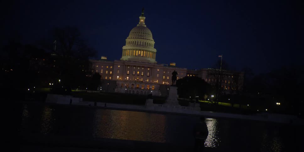 The large building is brightly lit at night