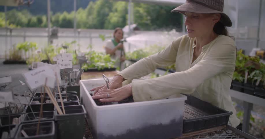 Two women are both working hard in the garden