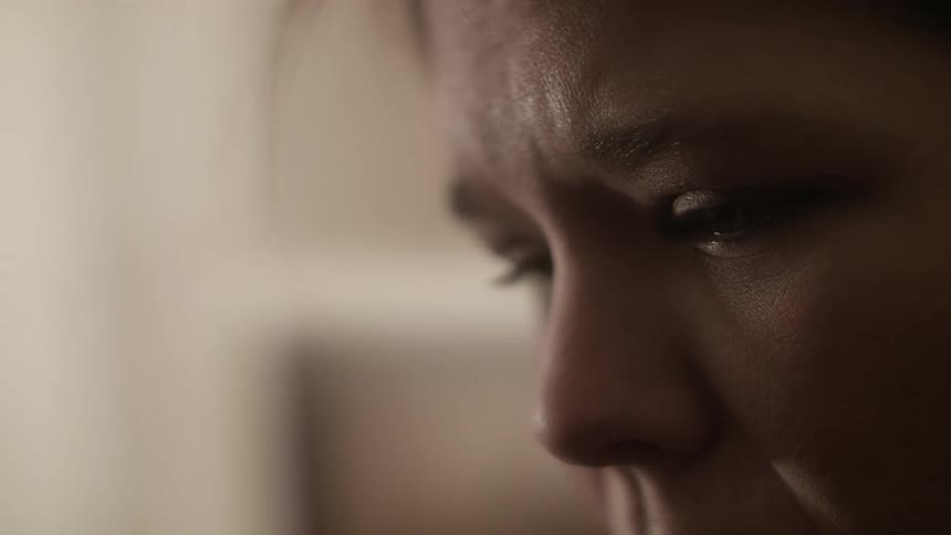 A woman is watching something intently