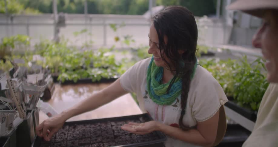 Two women are planting seeds