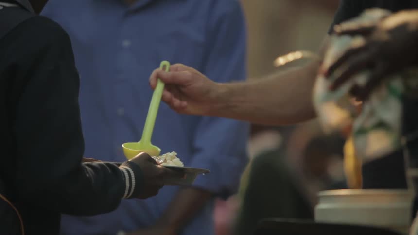 People serving food to people