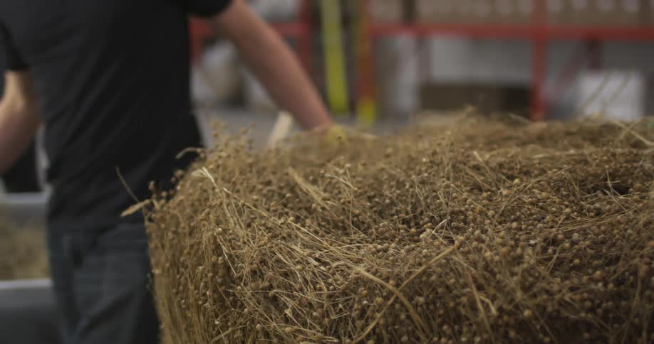 A bale of hay is moved