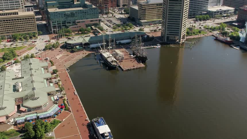 Two large ships are docked near the port of this city