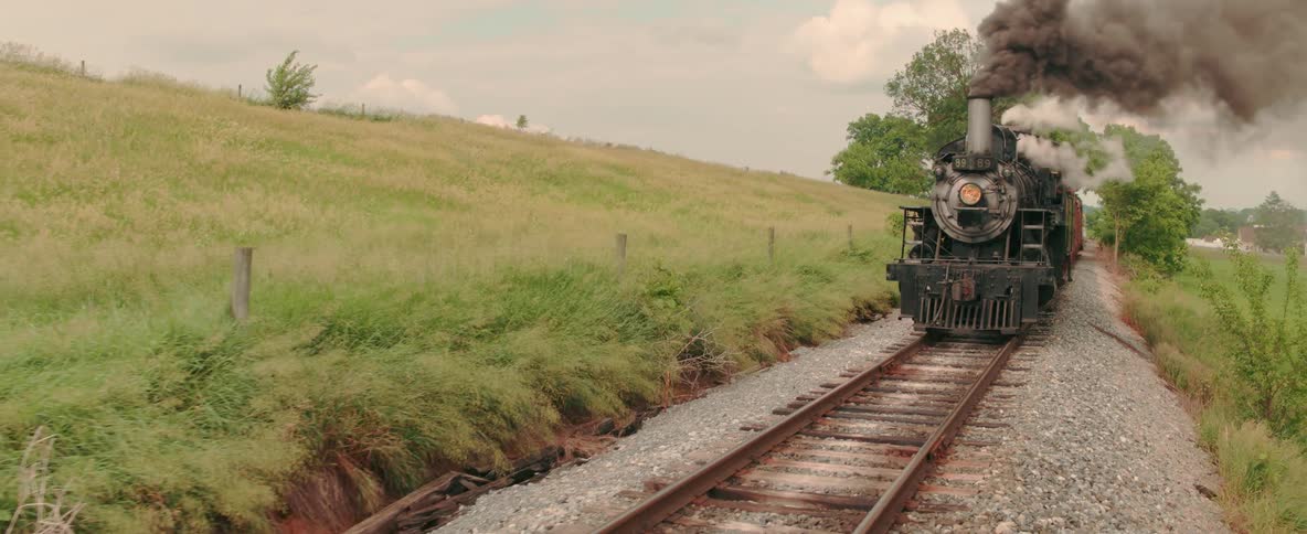 A coal powered train travels along the track