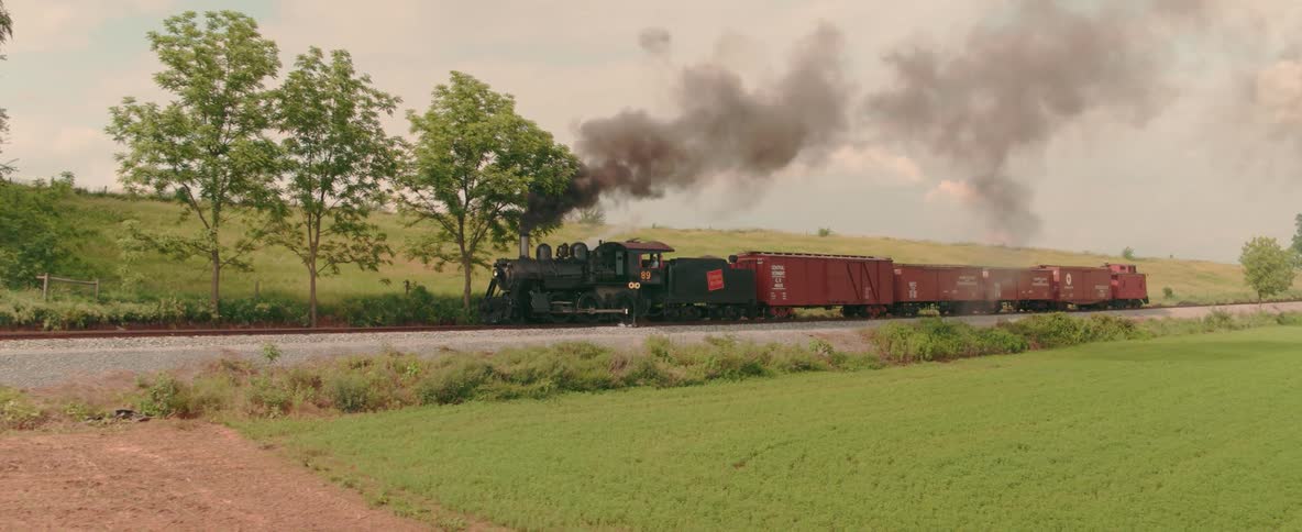 A train travels through a rural area