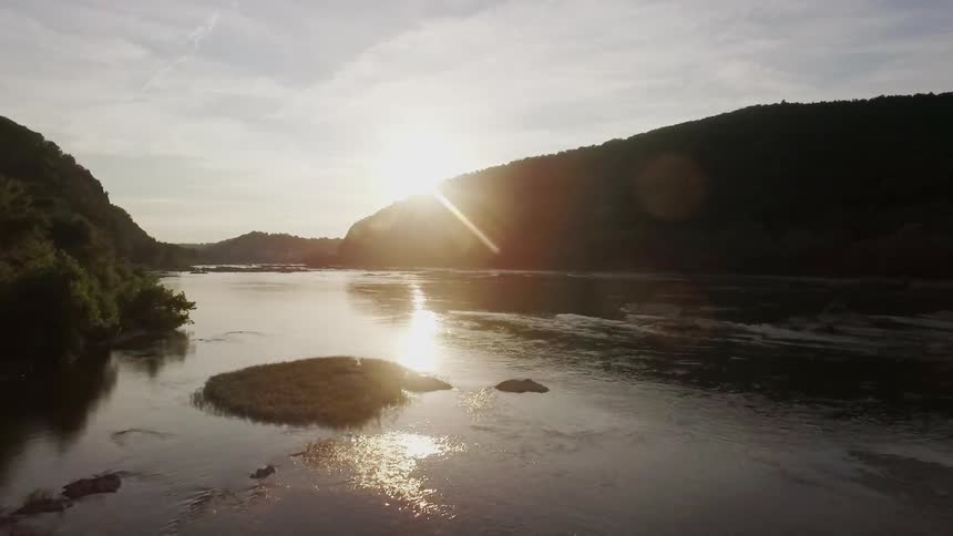 The sun is shining over a river