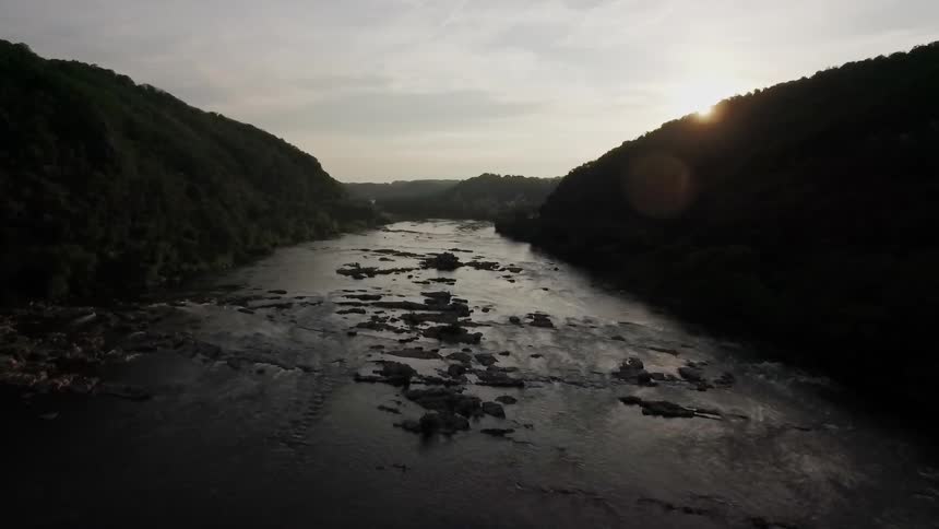 A drone is flying over a river valley