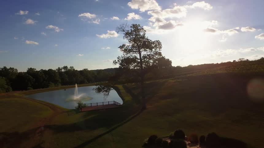 A man made lake with a fountain is shown from above