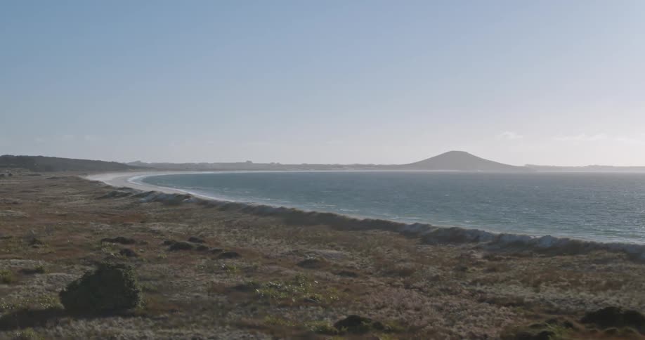 A grassy coastline is shown without people