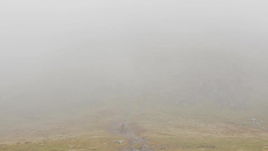 A man is jogging in the mist