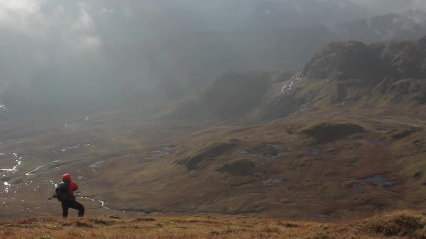 A woman is watching the mist roll in
