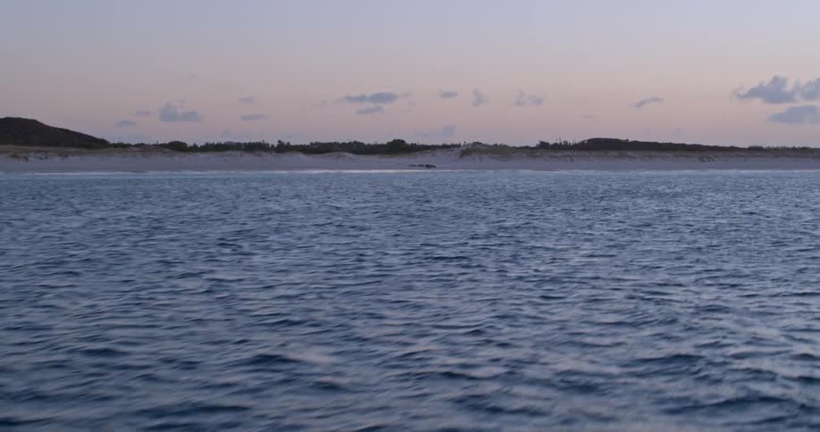 The water is rough by this shore at dawn