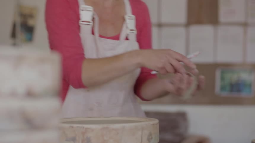 A woman is making a cake
