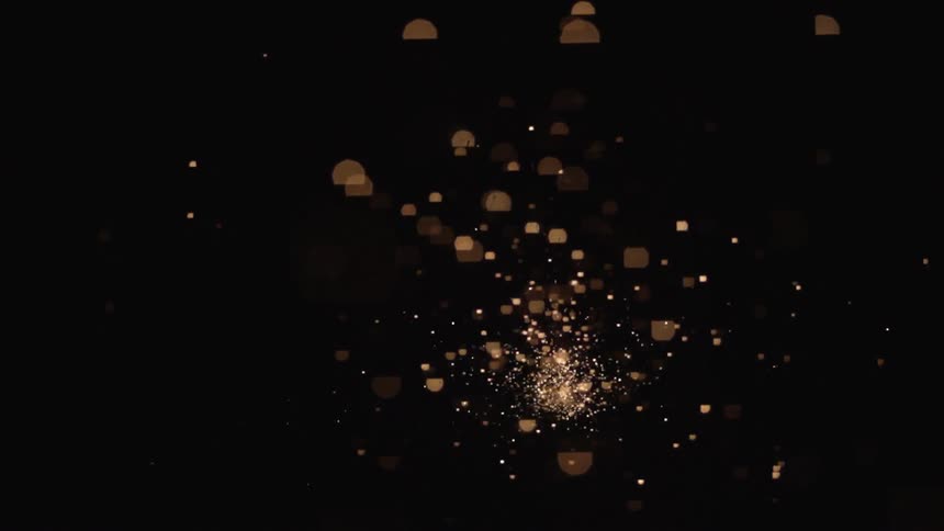 Sparks fly through the dark sky