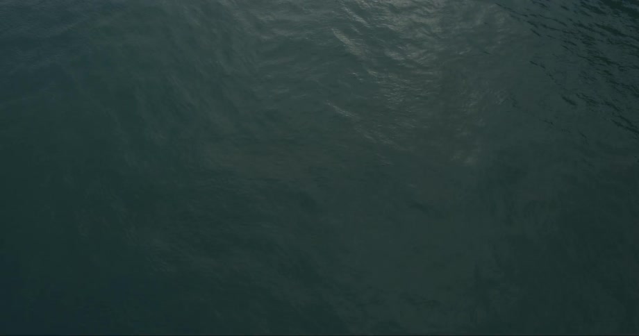Calm water is being filmed by a drone